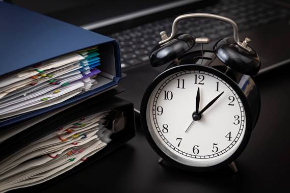 Clock next to paperwork - Wage claims